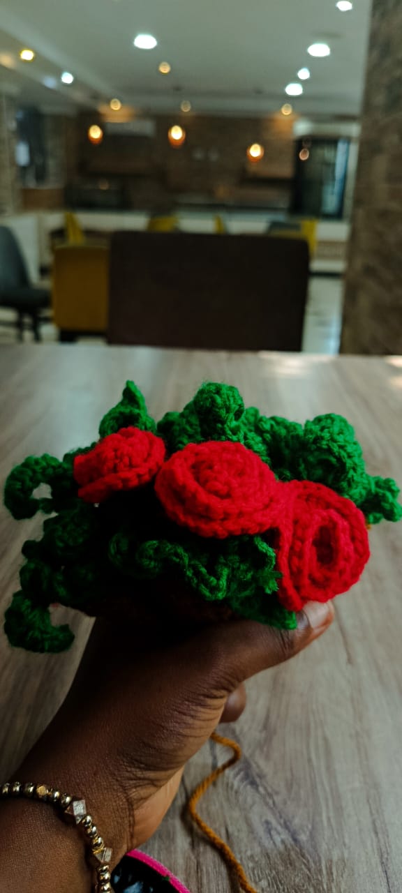 Crochet roses and leaves held up in the Atrium café